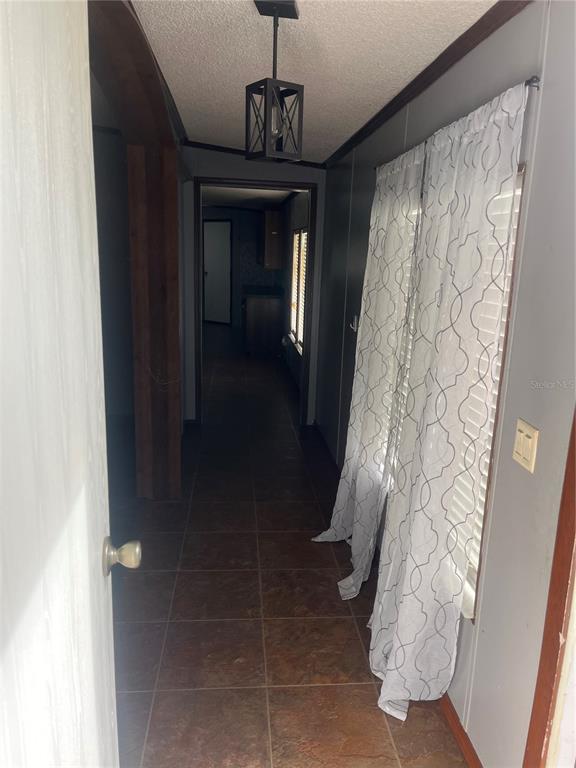 1145 Yaun Road Southeast Moore Haven, FL 33471 - Photo 5 of 26 a hallway with windows and flowers