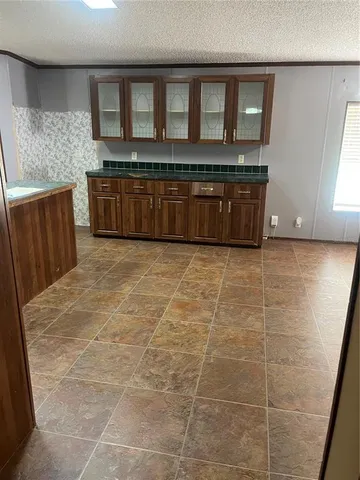 a view of a kitchen with an empty space and wooden floor
