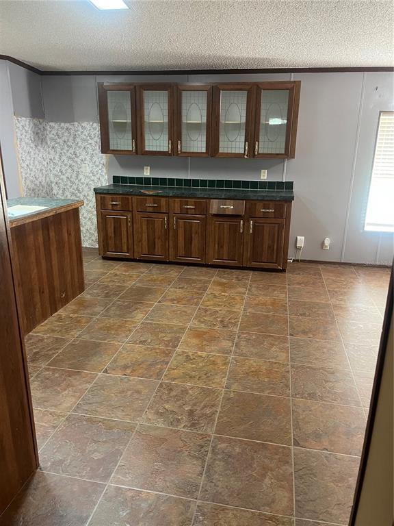 1145 Yaun Road Southeast Moore Haven, FL 33471 - Photo 8 of 26 a view of a kitchen with an empty space and wooden floor