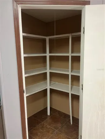 a view of walk in closet with empty racks