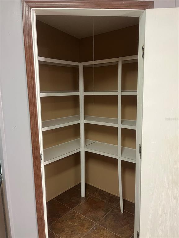 1145 Yaun Road Southeast Moore Haven, FL 33471 - Photo 10 of 26 a view of walk in closet with empty racks
