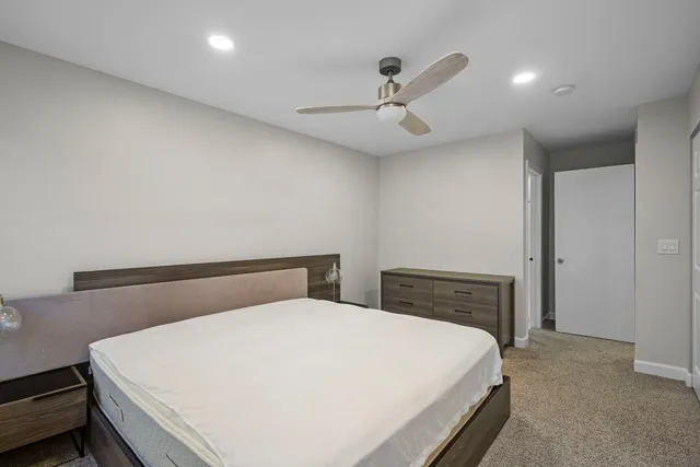 a bedroom with a large bed and a chandelier