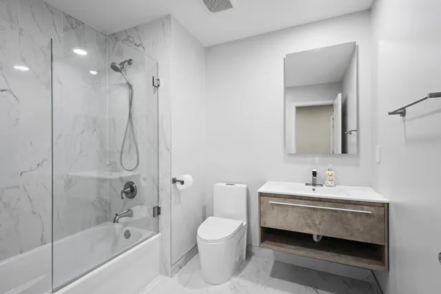 a bathroom with a sink toilet and shower