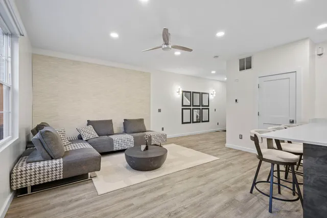 a living room with furniture and wooden floor
