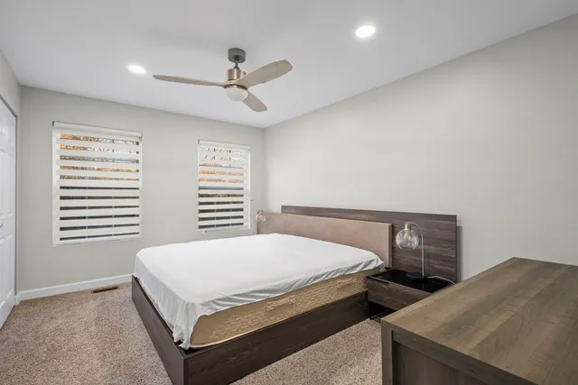 a bedroom with a bed and a window