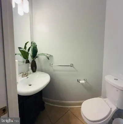 a bathroom with a sink mirror and toilet