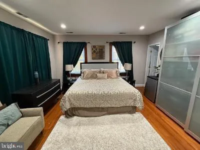 a bedroom with a bed window and tub