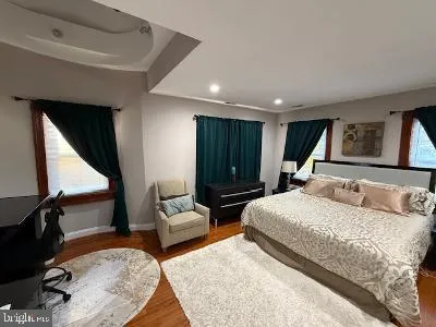 a spacious bedroom with a large bed and a dresser