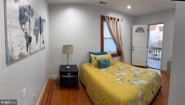 a bed sitting in a bedroom next to a window