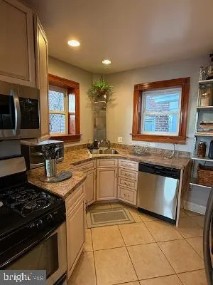 a kitchen with a stove sink and cabinets