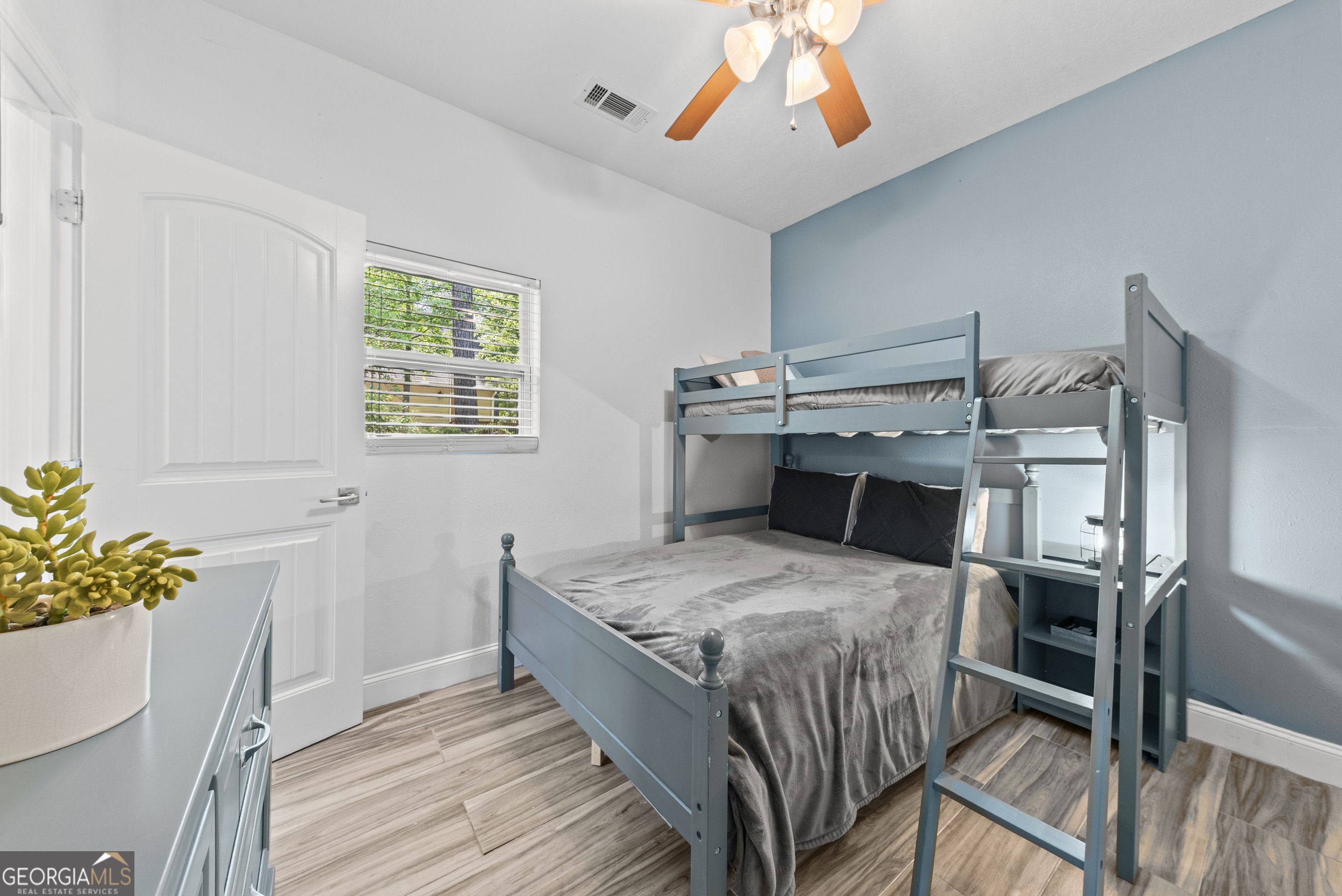 141 Edgewater Drive Eatonton, GA 31024 - Photo 60 of 85 a bedroom that has a bed and a table in it
