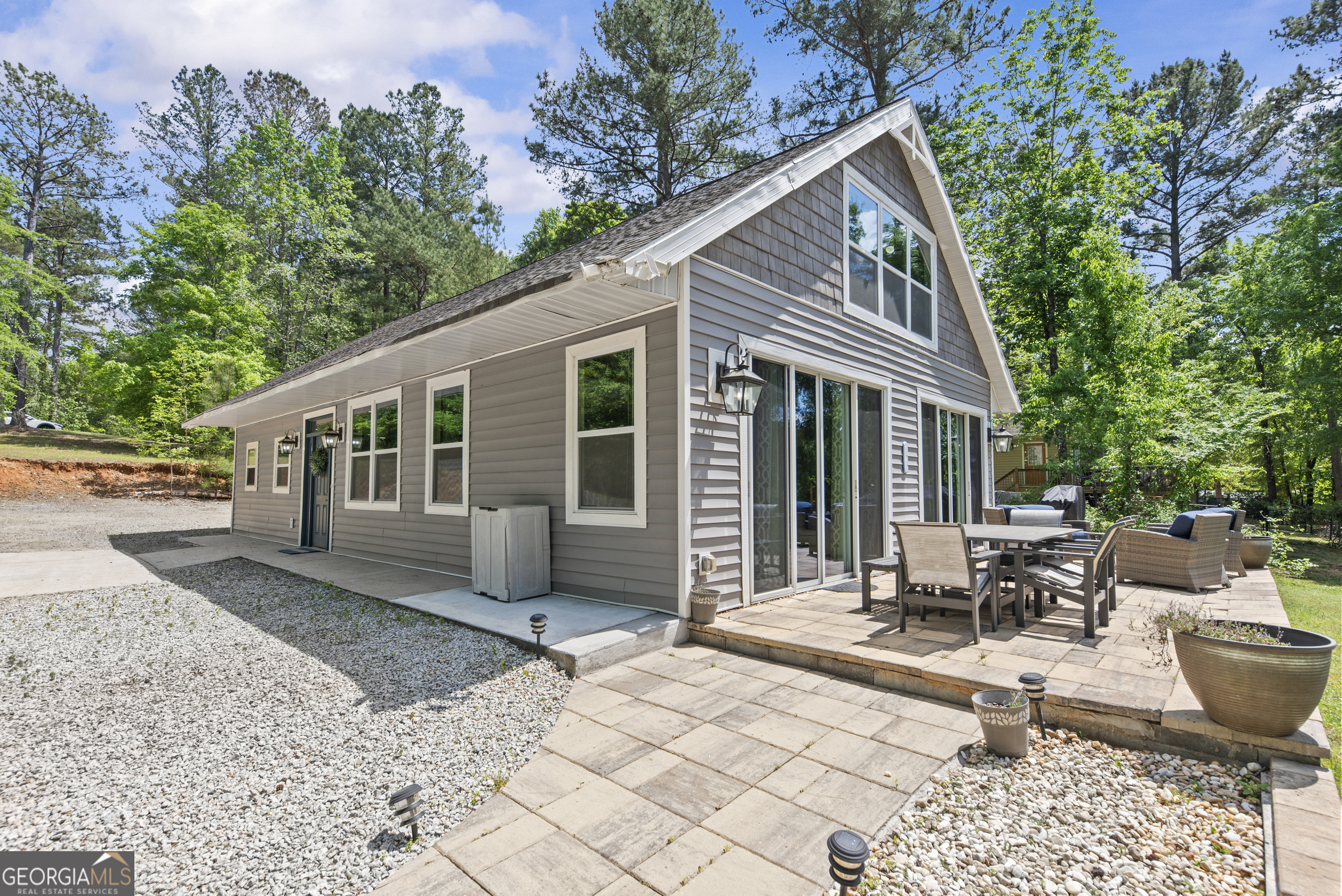 141 Edgewater Drive Eatonton, GA 31024 - Photo 6 of 85 a view of a house with backyard sitting area and garden