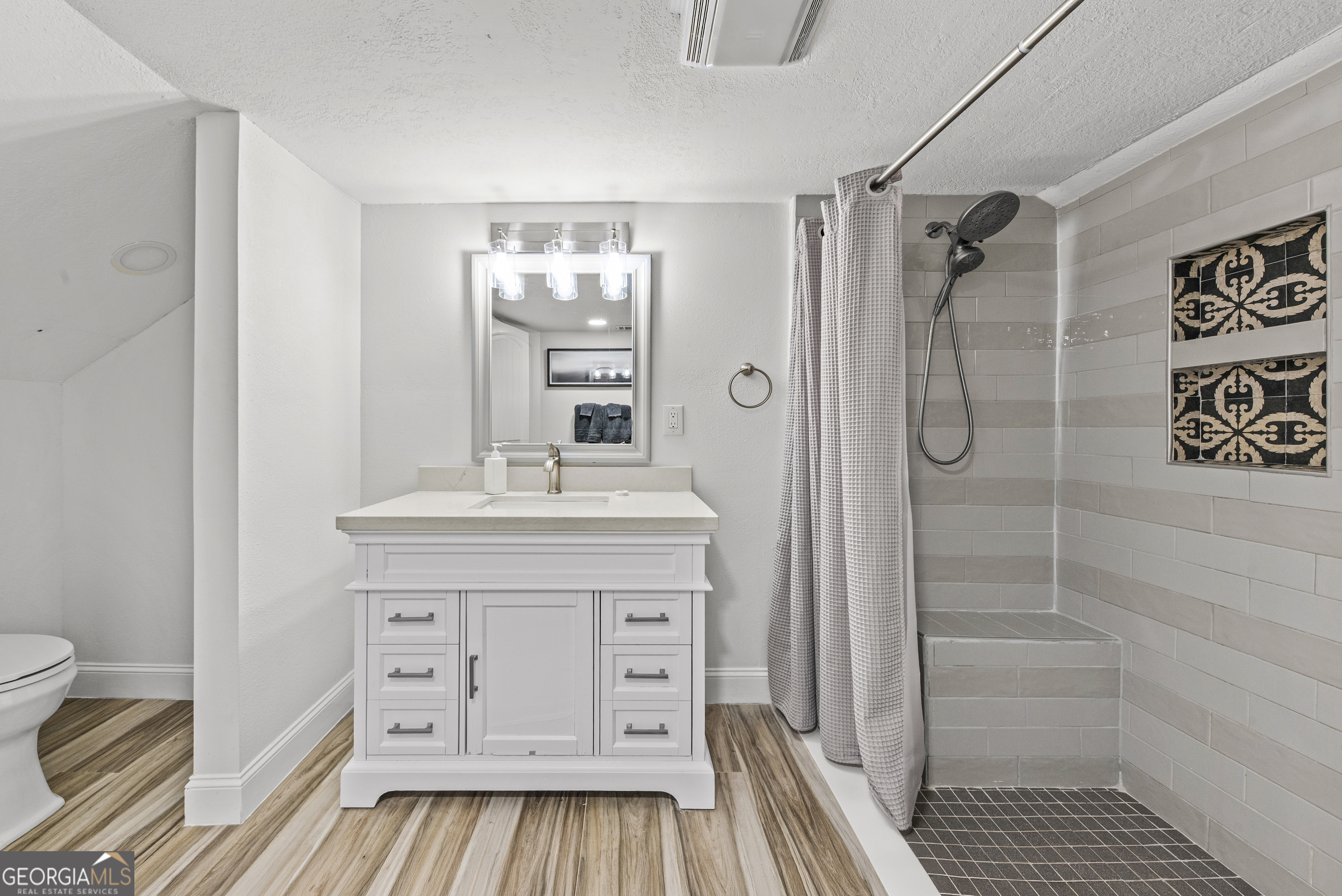 141 Edgewater Drive Eatonton, GA 31024 - Photo 64 of 85 a bathroom with a sink a toilet and shower