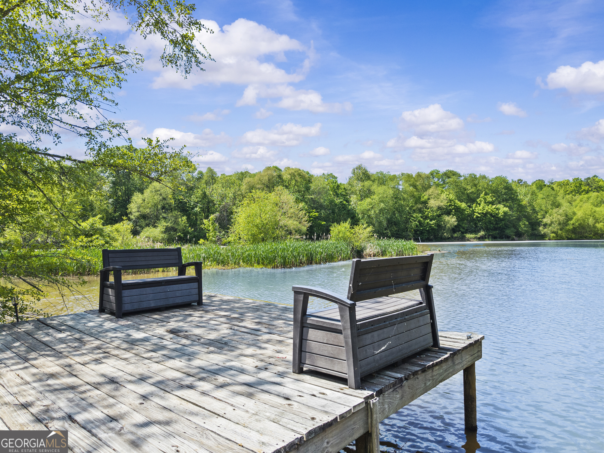 141 Edgewater Drive Eatonton, GA 31024 - Photo 84 of 85 a wooden bench sitting in the middle of a lake