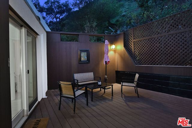 a view of a roof deck with wooden floor and a bench