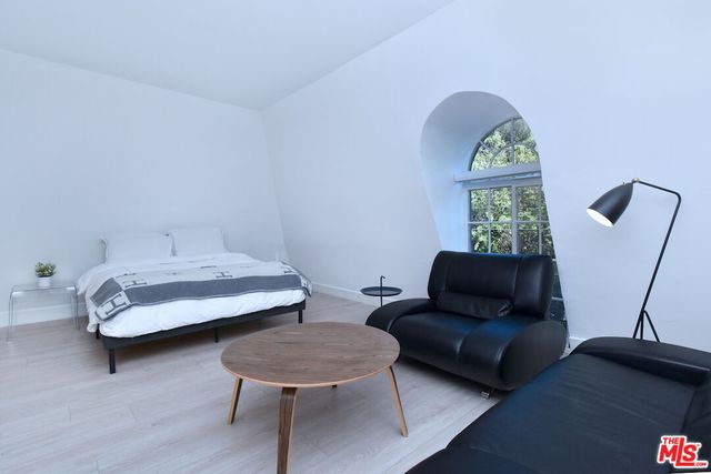 a bedroom with furniture and a window