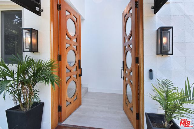 a view of an entryway with wooden floor and a potted plant