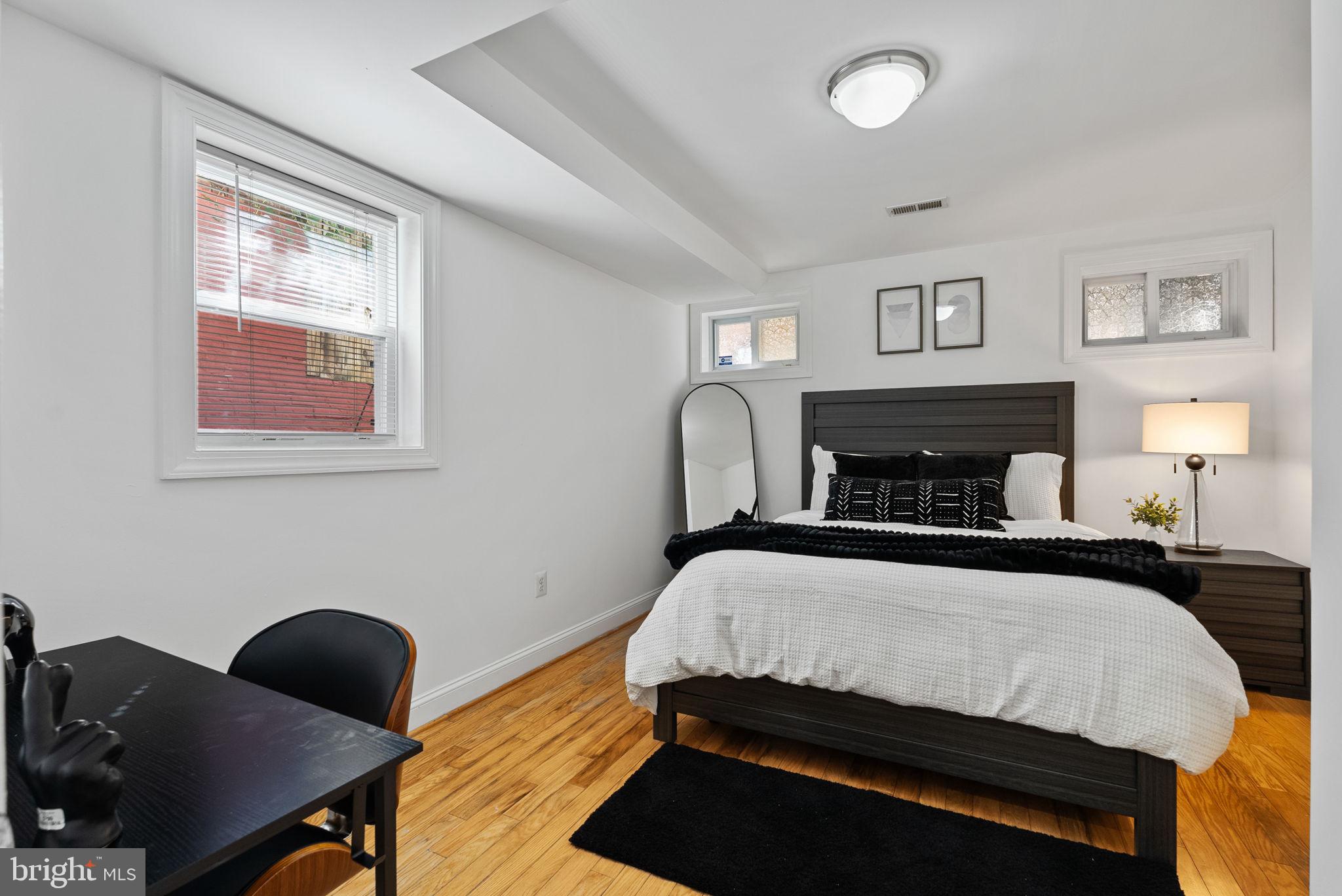 18 N Street Northwest, Unit 2 Washington, DC 20001 - Photo 11 of 24 a bedroom with a bed and a lamp next to a window