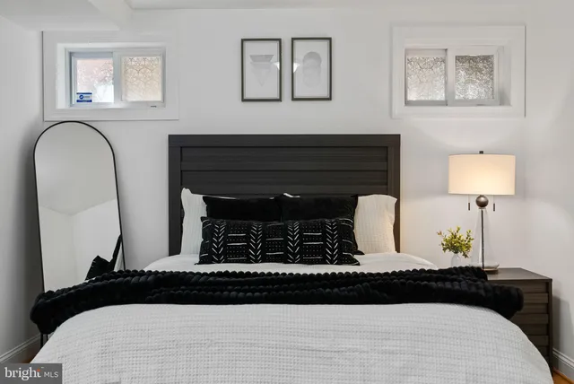 a bedroom with bed and wooden floor