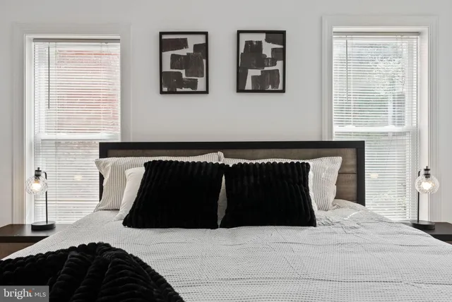 a bedroom with a bed and a window