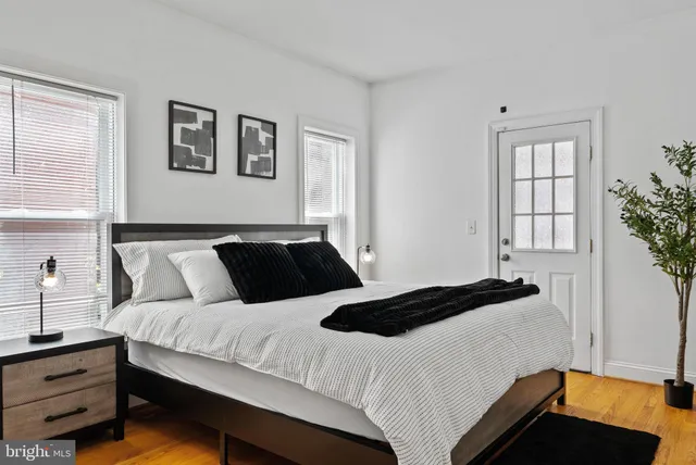 a bedroom with bed lamp and a window