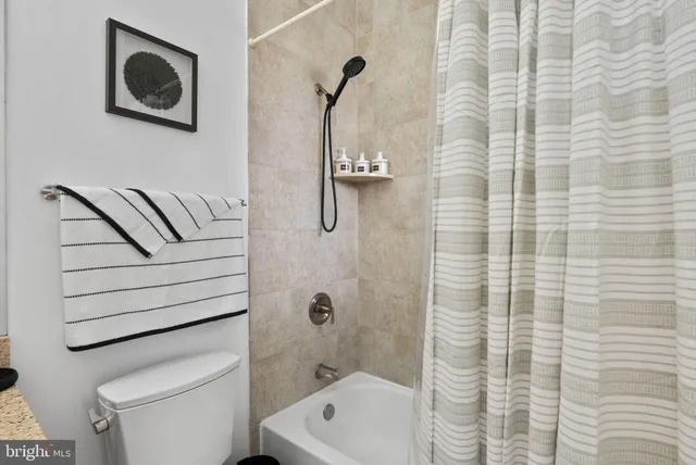 a bathroom with a shower a toilet and a sink