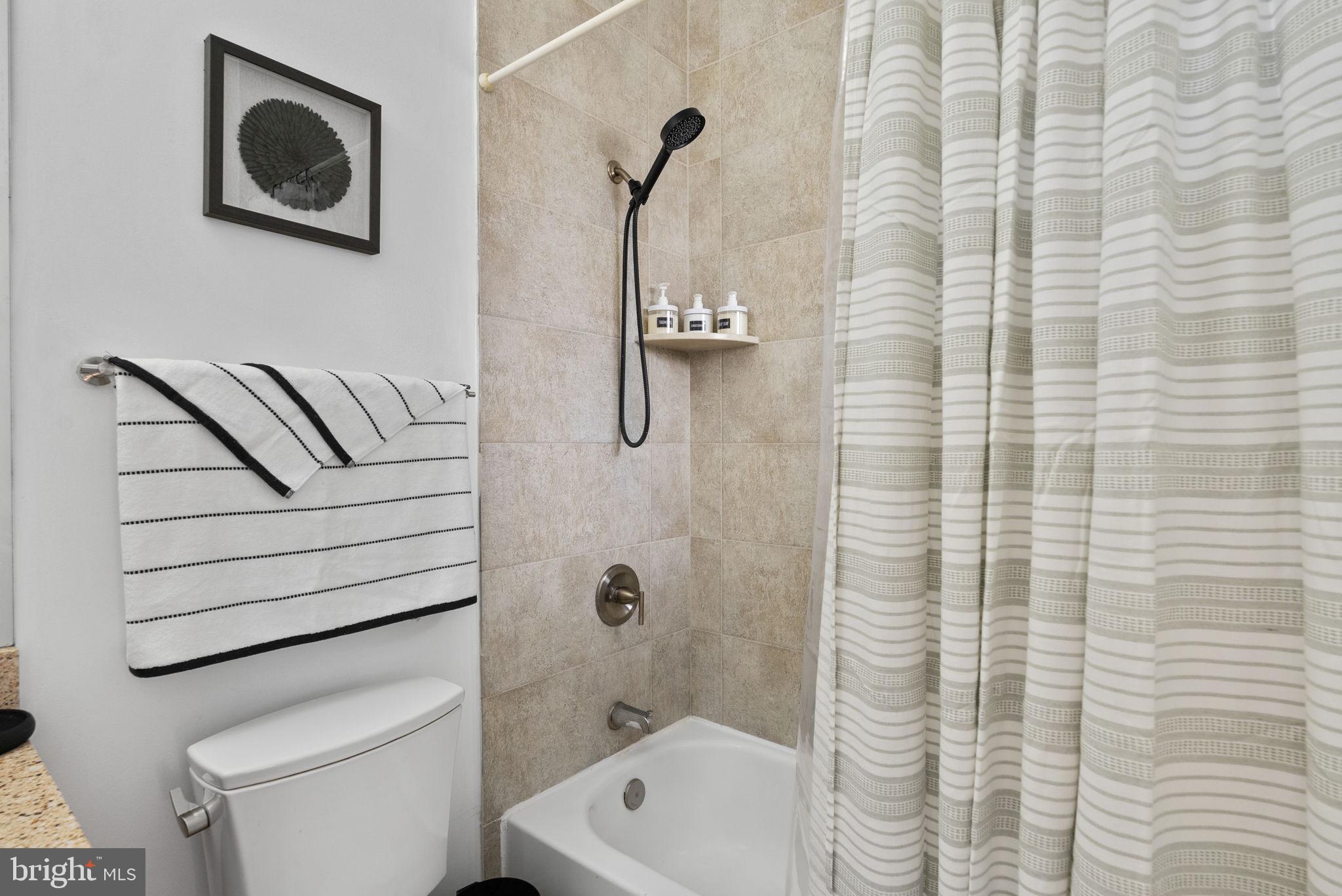 18 N Street Northwest, Unit 2 Washington, DC 20001 - Photo 22 of 24 a bathroom with a shower a toilet and a sink