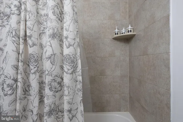 a bathroom with a shower and a sink