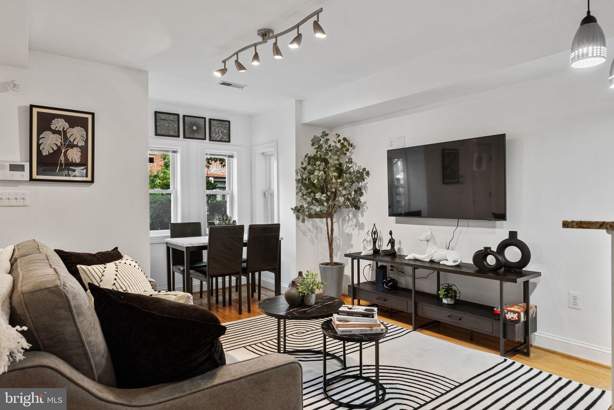 18 N Street Northwest, Unit 2 Washington, DC 20001 - Photo 3 of 24 a living room with furniture and a flat screen tv