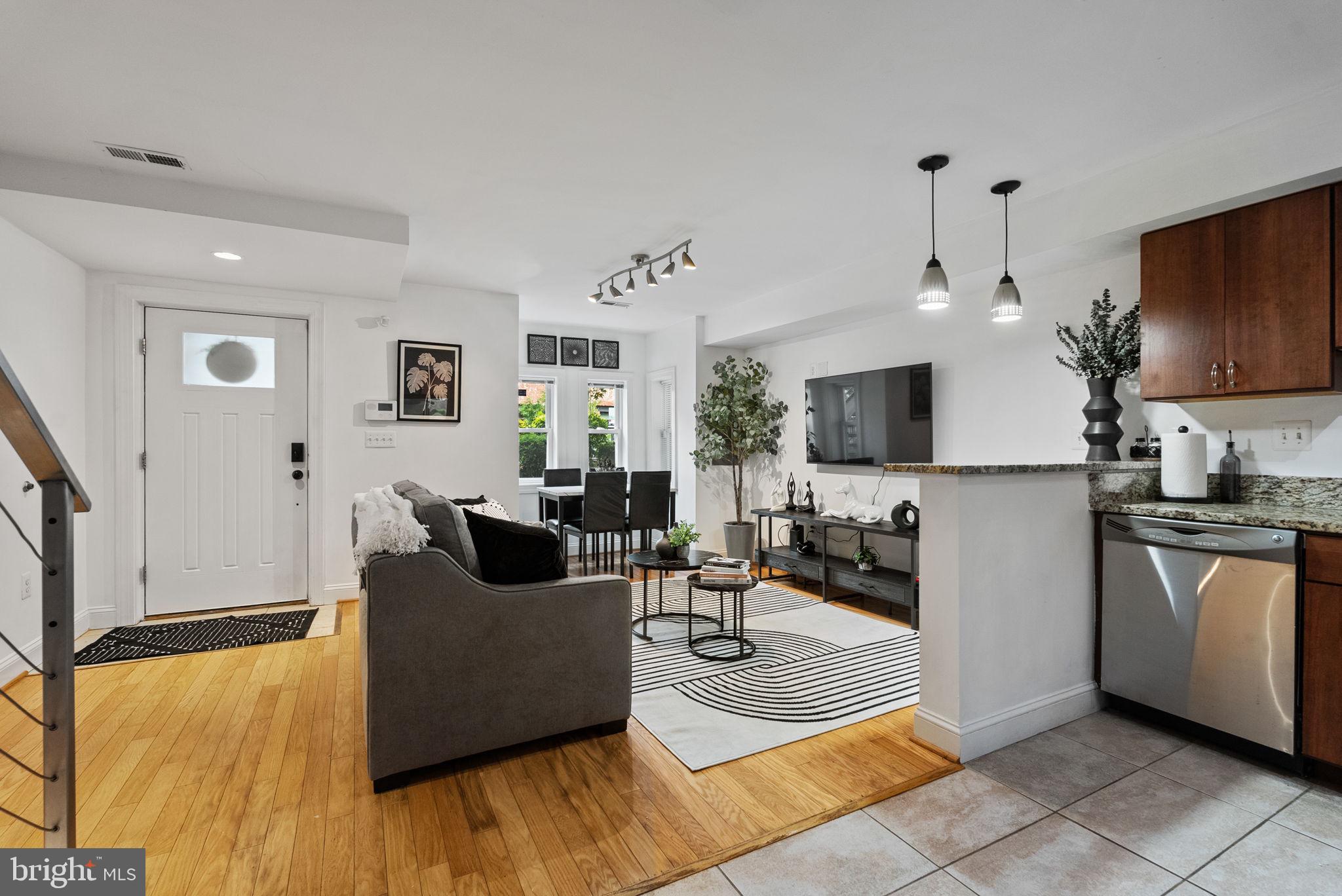 18 N Street Northwest, Unit 2 Washington, DC 20001 - Photo 4 of 24 a living room with stainless steel appliances furniture a flat screen tv and a refrigerator