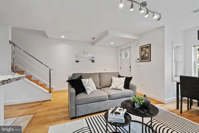 a living room with furniture and a rug