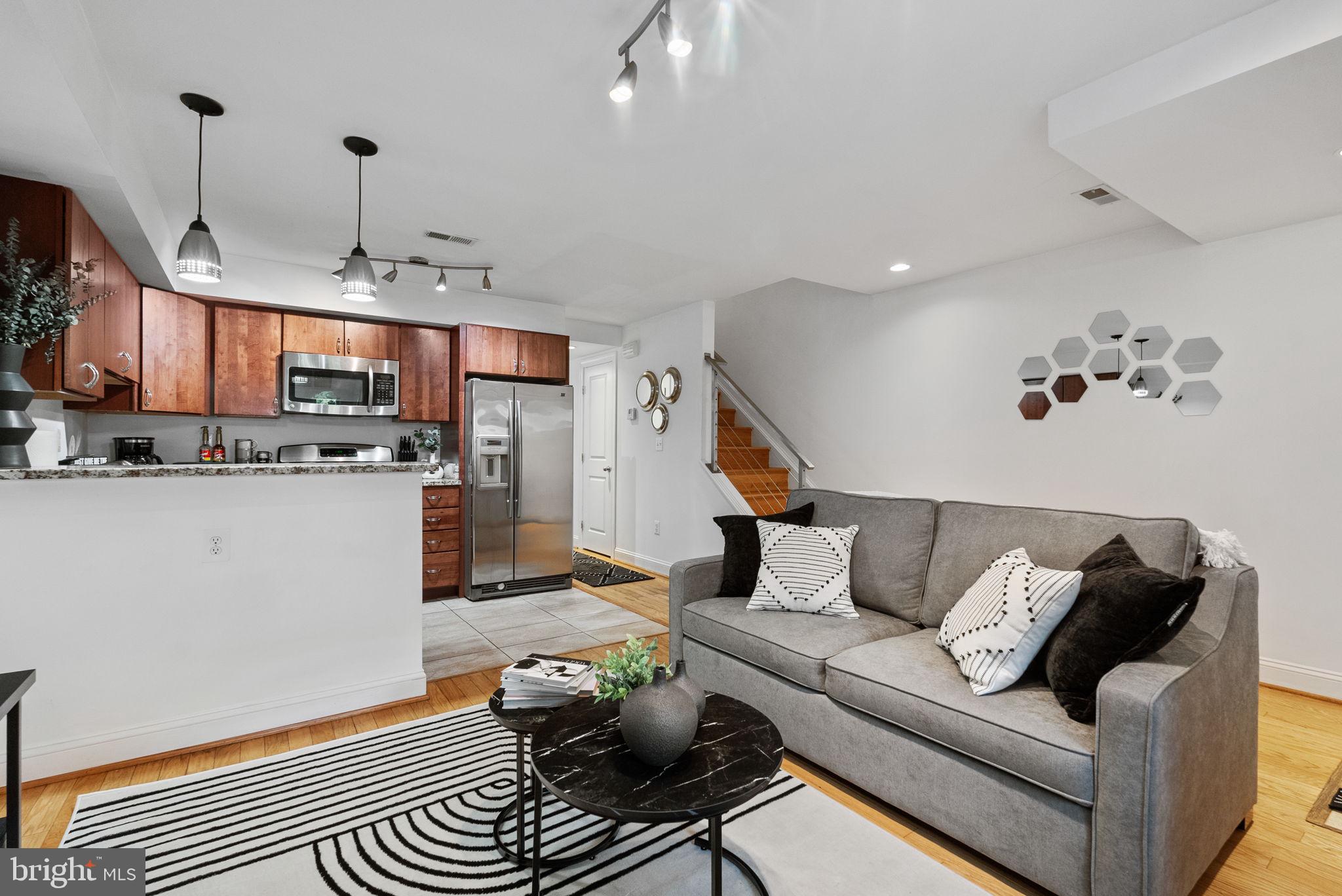 18 N Street Northwest, Unit 2 Washington, DC 20001 - Photo 7 of 24 a living room with furniture kitchen view and a chandelier