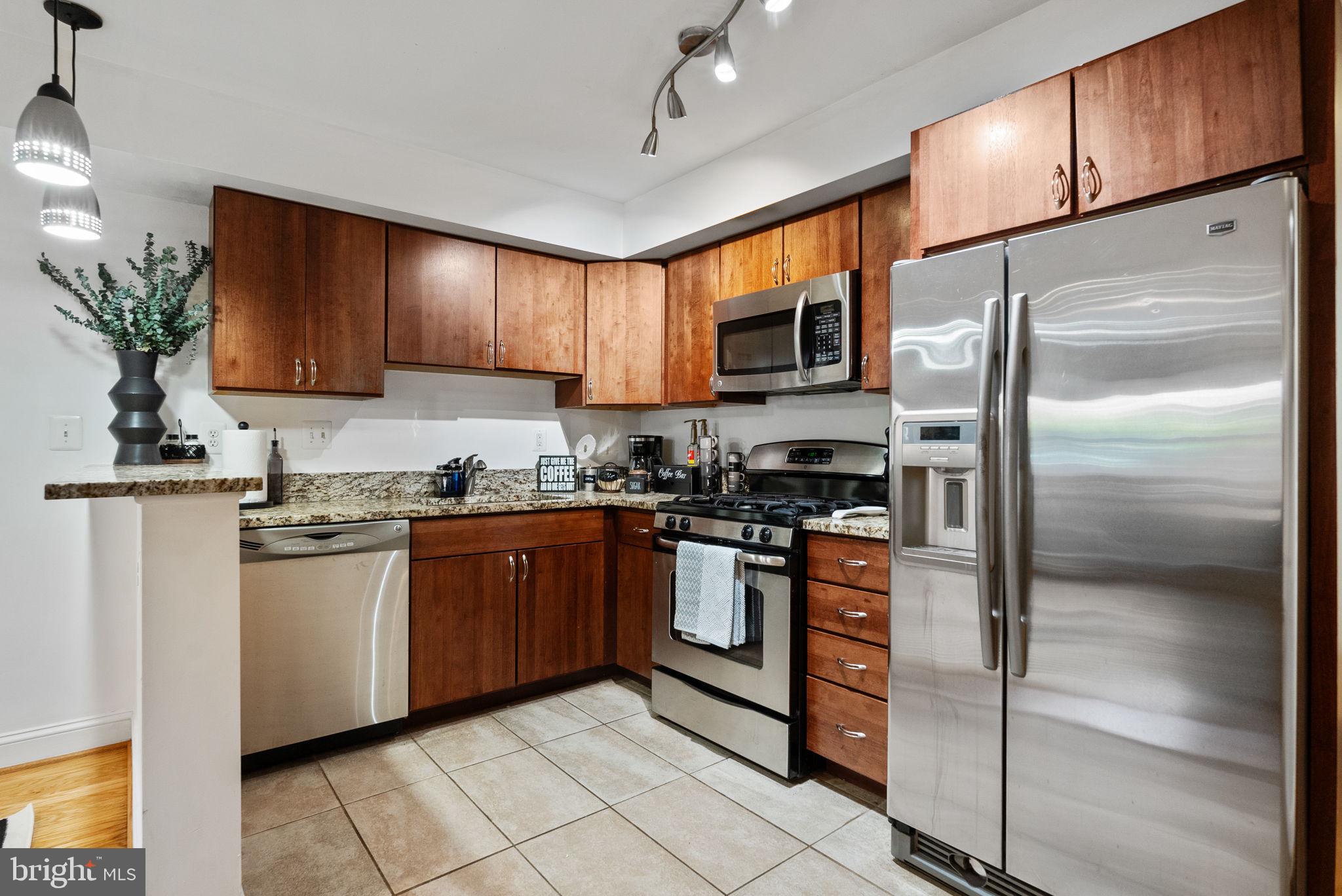 18 N Street Northwest, Unit 2 Washington, DC 20001 - Photo 8 of 24 a kitchen with stainless steel appliances granite countertop a refrigerator a stove a sink and a microwave