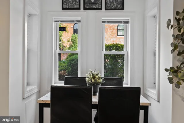 a dining room with furniture and window