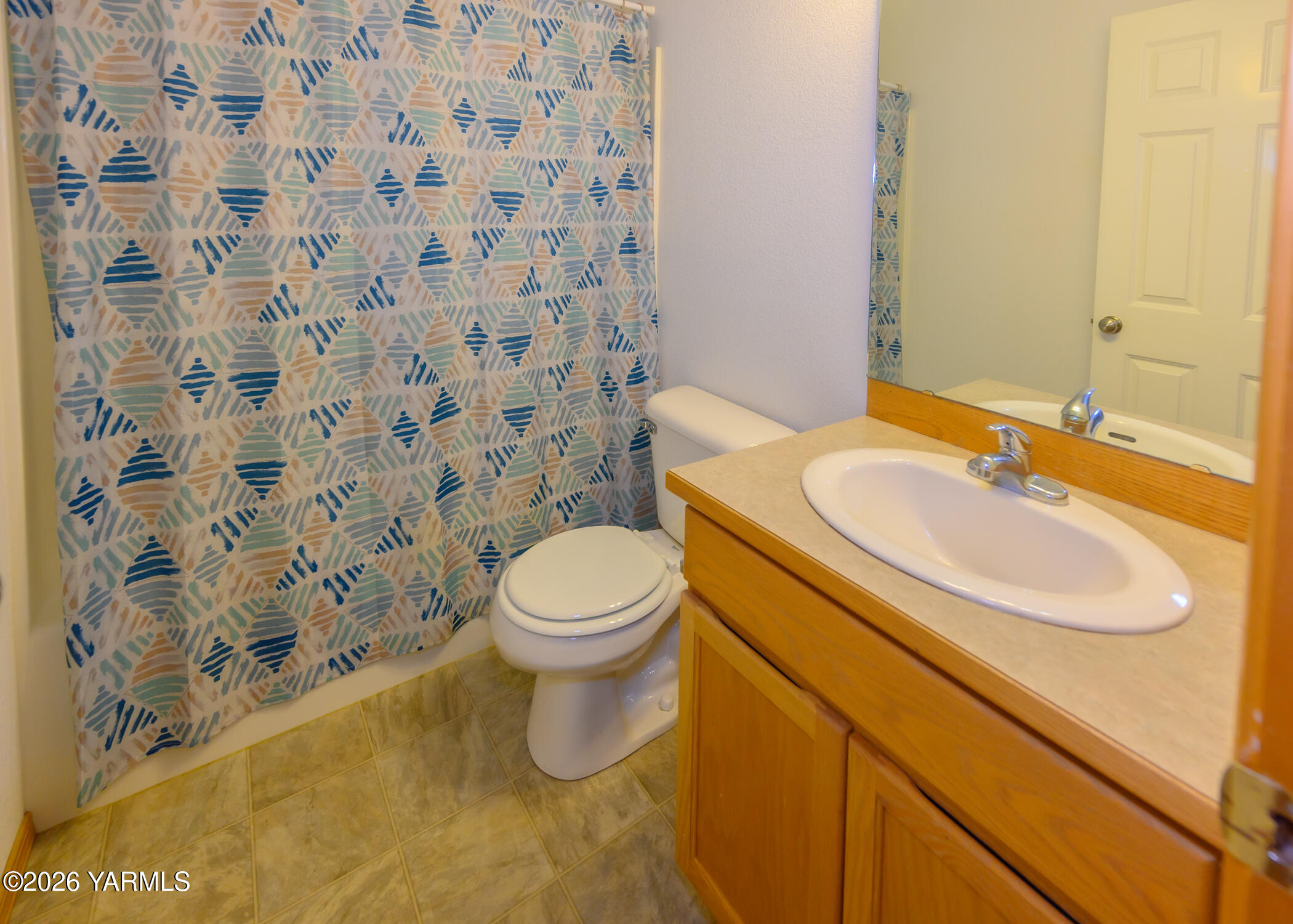 115 Lyle Loop Selah, WA 98942 - Photo 28 of 42 a bathroom with a sink a toilet and shower curtain