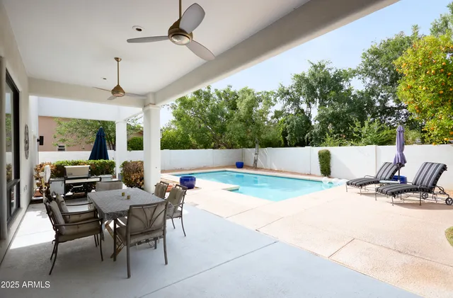 a view of a house with swimming pool and sitting area