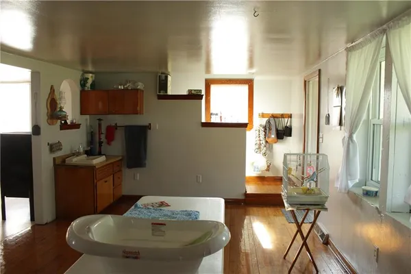 a dining room with furniture and wooden floor