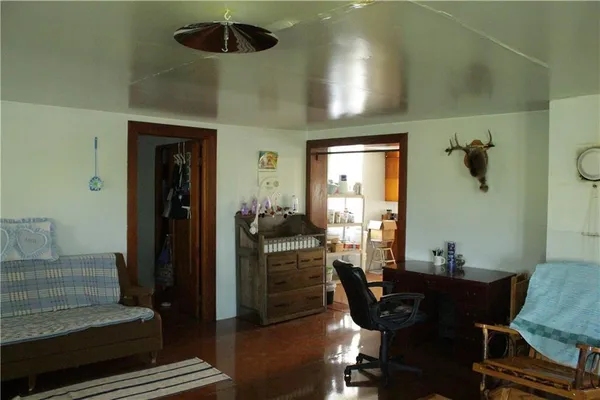 a view of a livingroom with furniture and a window