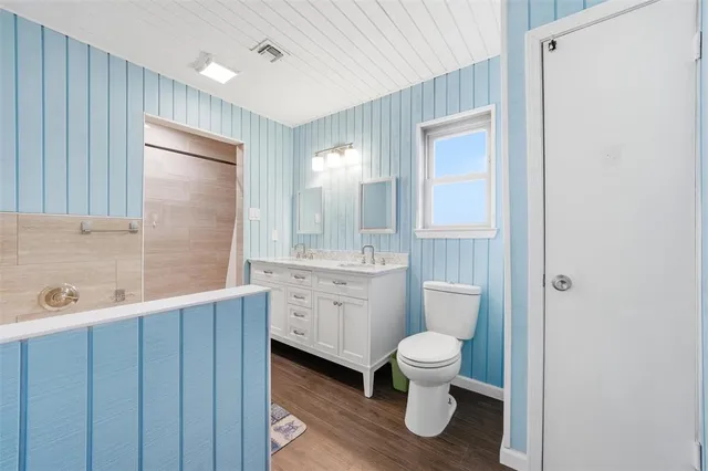 a bathroom with a toilet a sink a tub and mirror