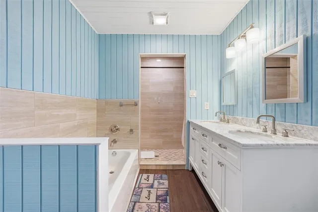 a bathroom with a double vanity sink a toilet and shower