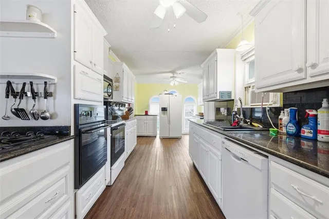 a kitchen with lots of counter top space and wooden floor