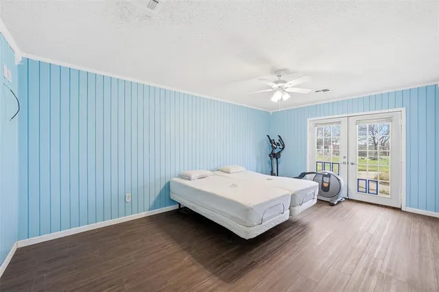 a spacious bedroom with a bed and a chandelier