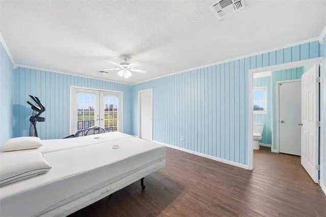 a room with a bed and wooden floor