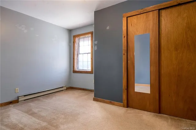 an empty room with windows and closet