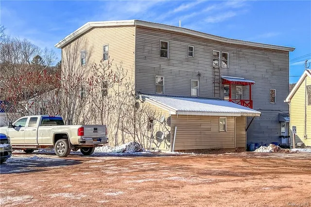 a view of a couches and dinning table and chairs