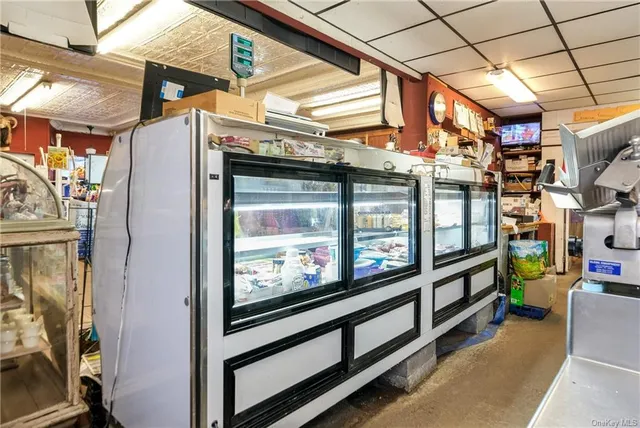 a room with table chairs and stainless steel appliances