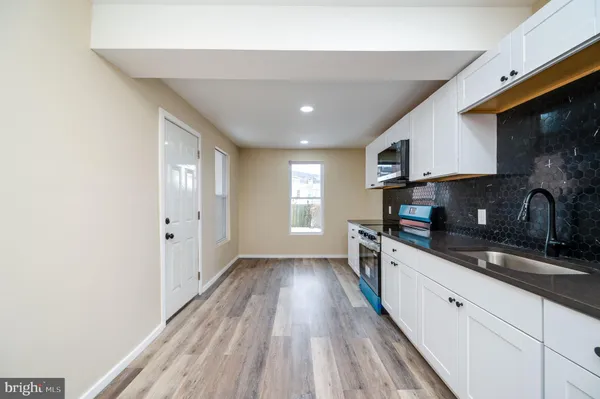 a kitchen with wooden floors and a sink