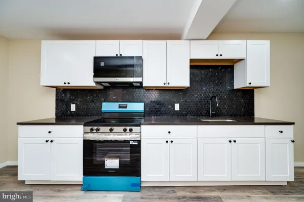 a kitchen with stainless steel appliances granite countertop a stove a microwave and oven