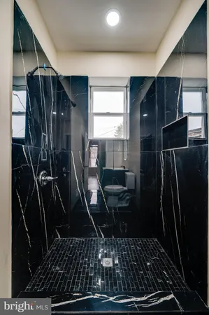 a bathroom with a toilet and a shower