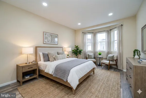 a bedroom with a bed and a couch